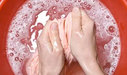 Washing fabric by hand in a bucket