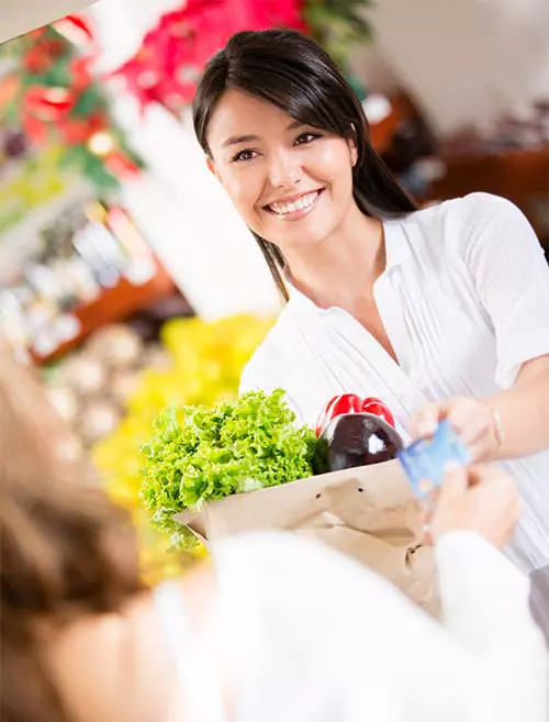 grocery shopper paying at checkout