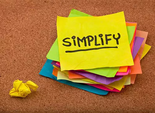 pragmatic or get organized concept, simplify reminder - a stack of colorful sticky notes on cork bulletin board