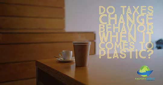 White Ceramic Teacup and brown paper cup sitting on a table