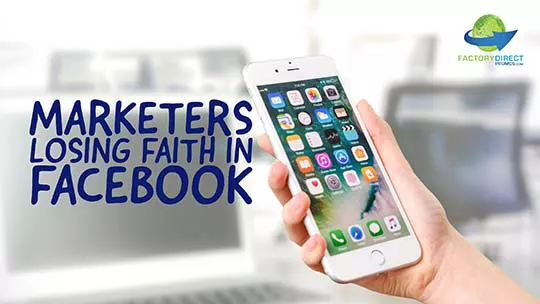 Hand holding an iPhone with unlock screen with caption: Marketers Losing Faith in Facebook