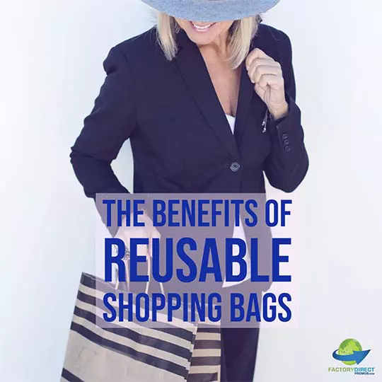 Woman with navy blue suit and wide brim hat holding a shopping bag
