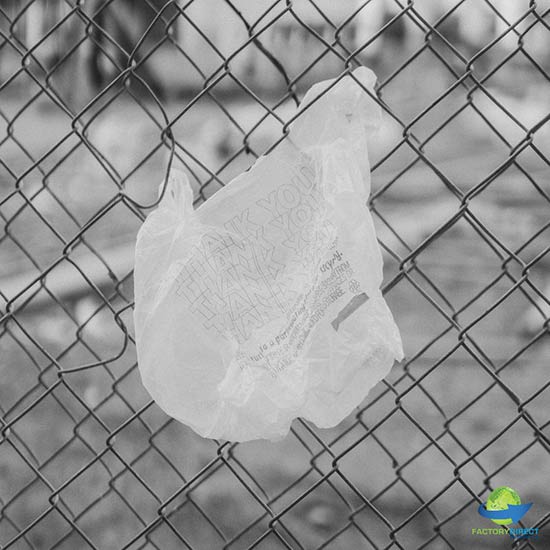 Single use plastic bag litter caught on a chain-link fence