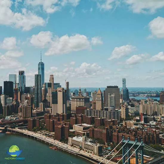 Daytime aerial shot of New York City skyline against blue sky