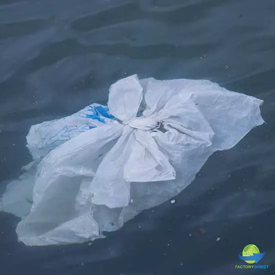 Single use plastic bag litter floating in water that contributes to microplastics