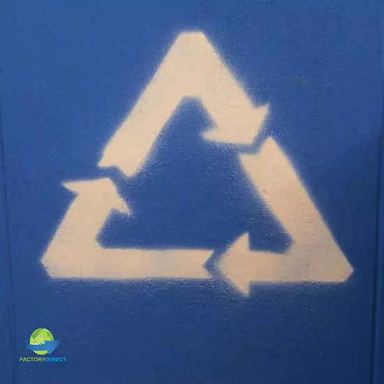 close-up of white spray painted recycle logo on blue background