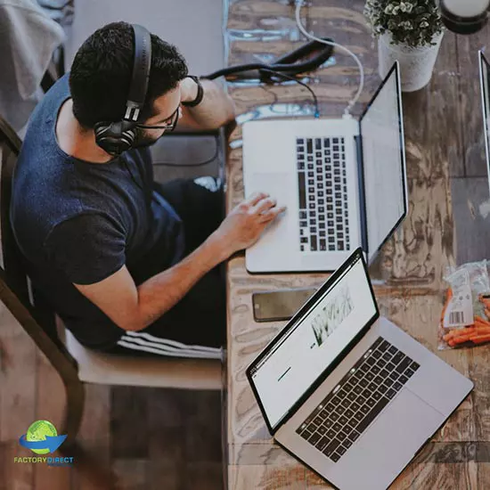 Overhead view of man with headphones working on laptop computer