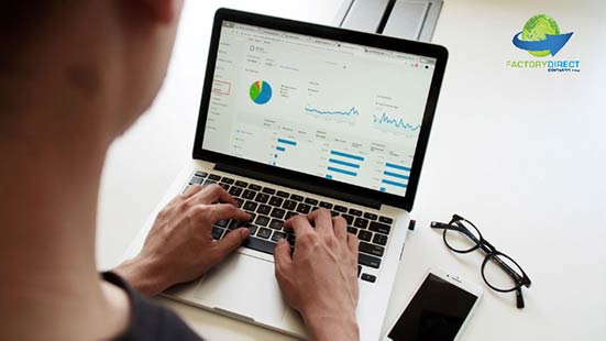 A computer user reviewing a dashboard of data on a laptop