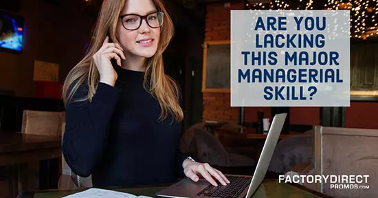 Girl with glasses on working on laptop with telephone headset