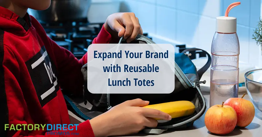 Boy putting food into a reusable lunch tote.