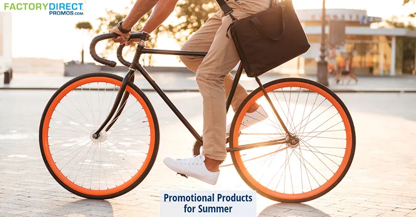 Man on a bicycle with orange rims wearing a messenger bag. Promotional Products for Summer.