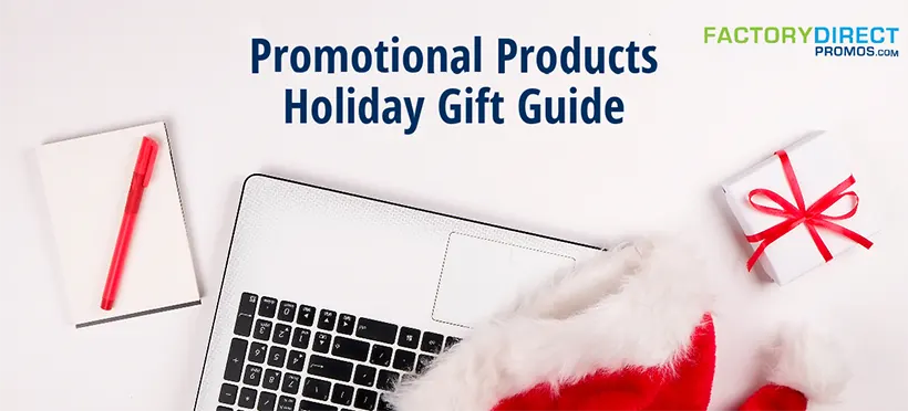 Santa hat on laptop with pen and gift — Promotional Products Holiday Gift Guide